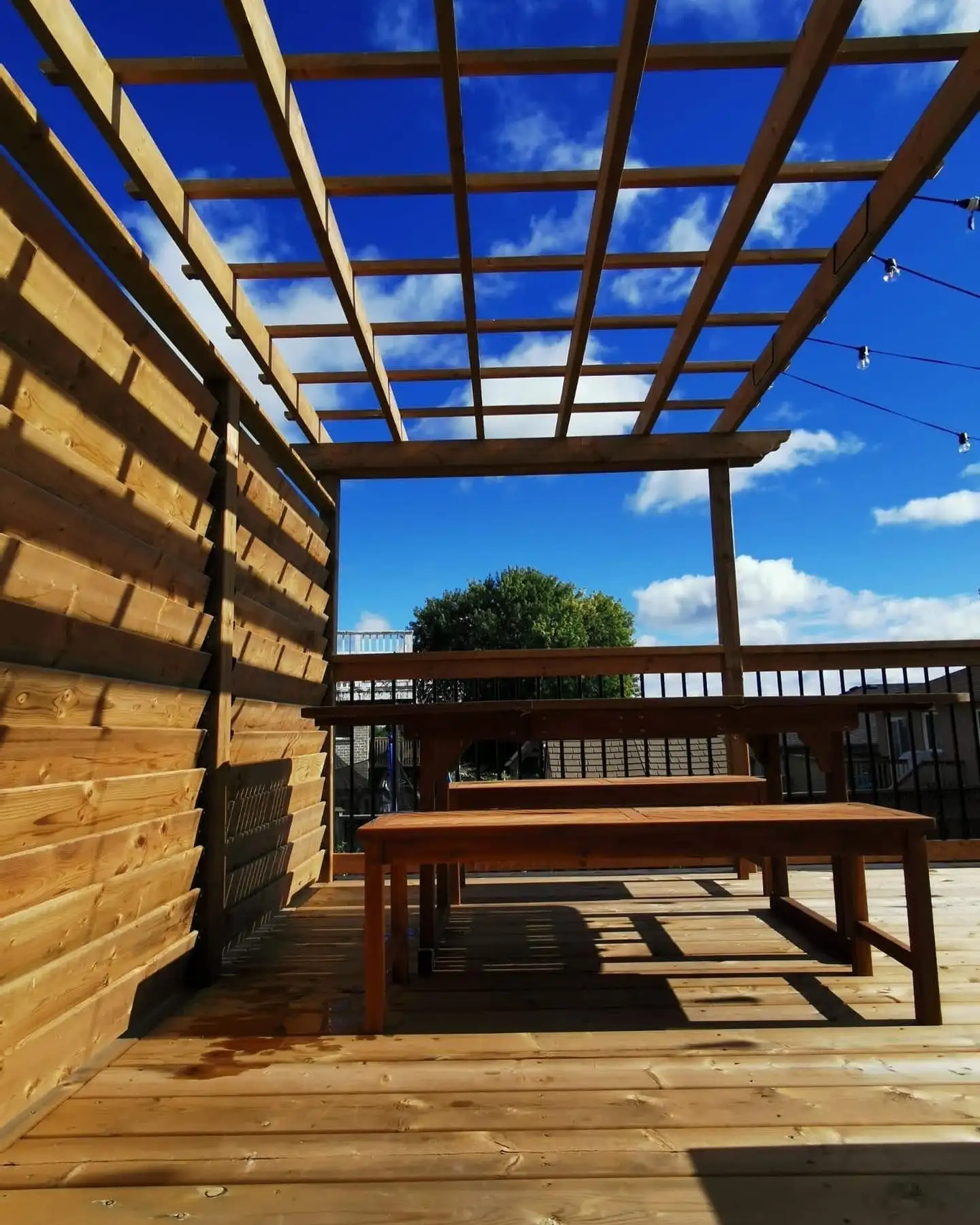 A custom deck with pergola built by Custom Home Works